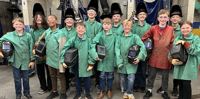 Group of students in welding clothes